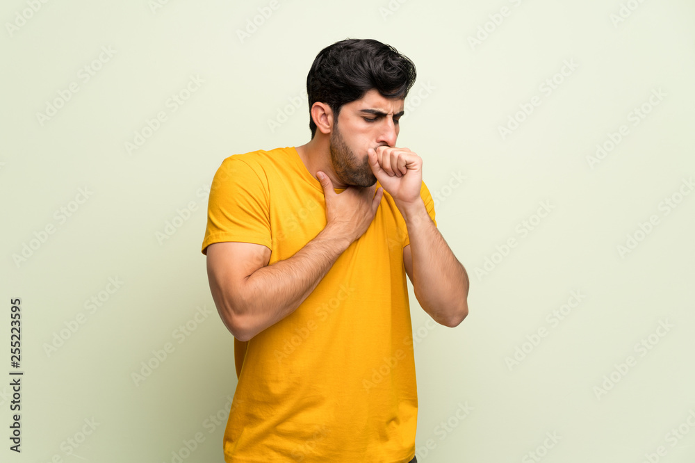 Young man over pink wall is suffering with cough and feeling bad Young man over pink wall is suffering with cough and feeling bad