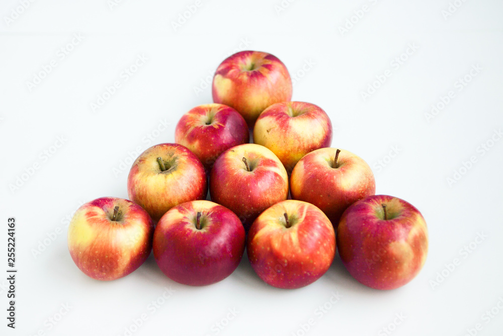 Red apples in the form of pyramid on the white ground Red apples in the form of pyramid on the white ground