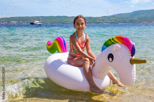 Girl on the unicorn on the sea