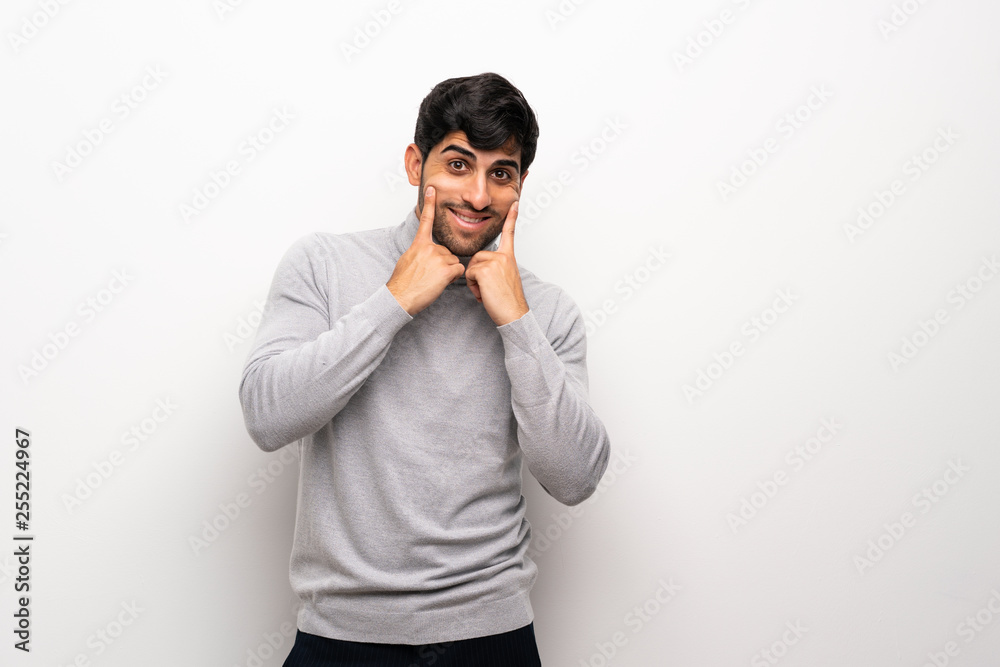 Young man over isolated white wall smiling with a happy and pleasant expression Young man over isolated white wall smiling with a happy and pleasant expression
