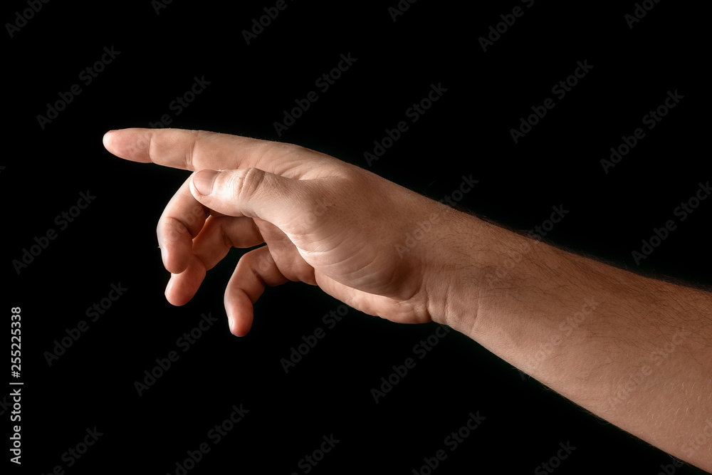 Man's hand touching or pointing to something isolated on black background. Close up. High resolution. Man's hand touching or pointing to something isolated on black background. Close up. High resolution.