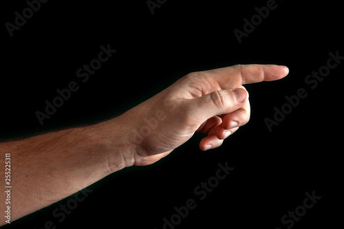 Man's hand touching or pointing to something isolated on black background. Close up. High resolution.