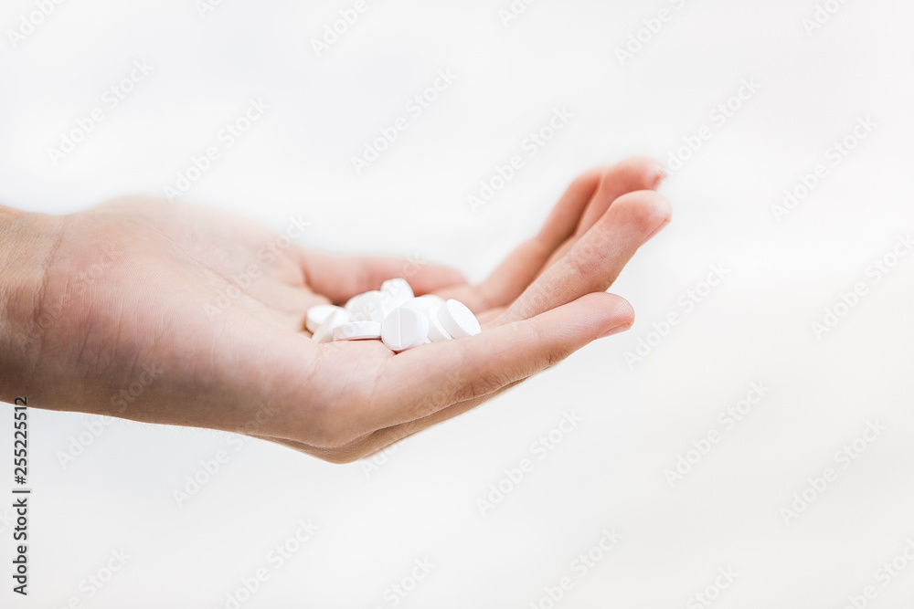 White pills in hand