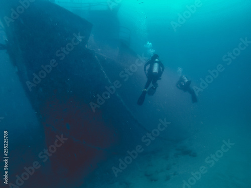 scuba diver in the sea with ship wreck