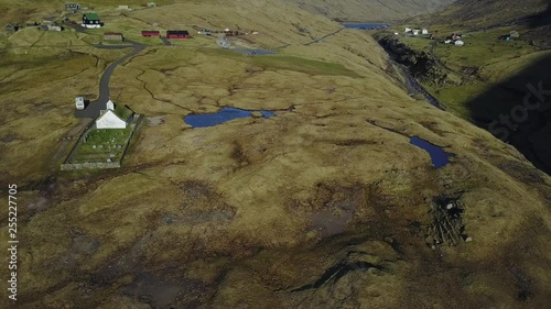 Small village church in Saksun and a nearby lake located on the island of Streymoy, Faroe Islands, Denmark. Shooting a drone quadrocopter,