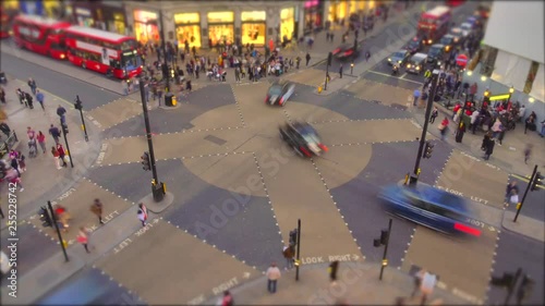 Time lapse of Oxford circus and regent street junction with rush hour traffic of both pedestrians, cars and Red double deck buses. photo