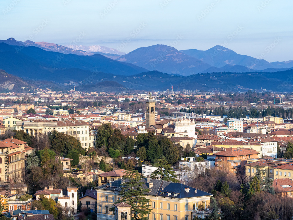 Alps mountain and Lower Town of Bergamo in evening