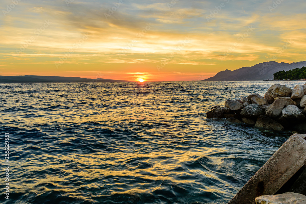 Beautiful sunset at the sea. Tourist village Baška Voda, Dalmatia region, Croatia