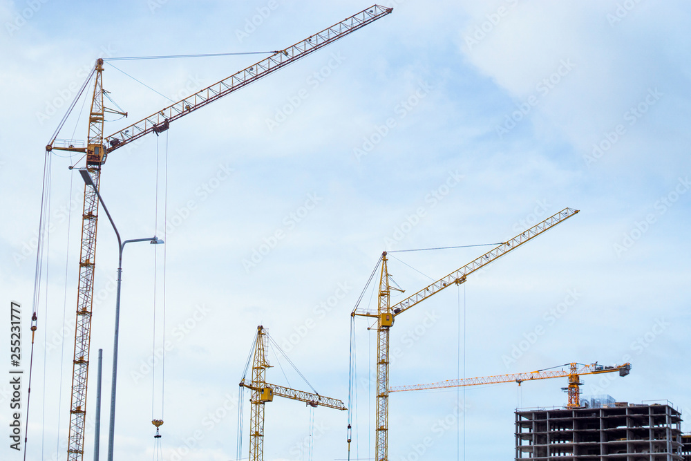 construction cranes build houses
