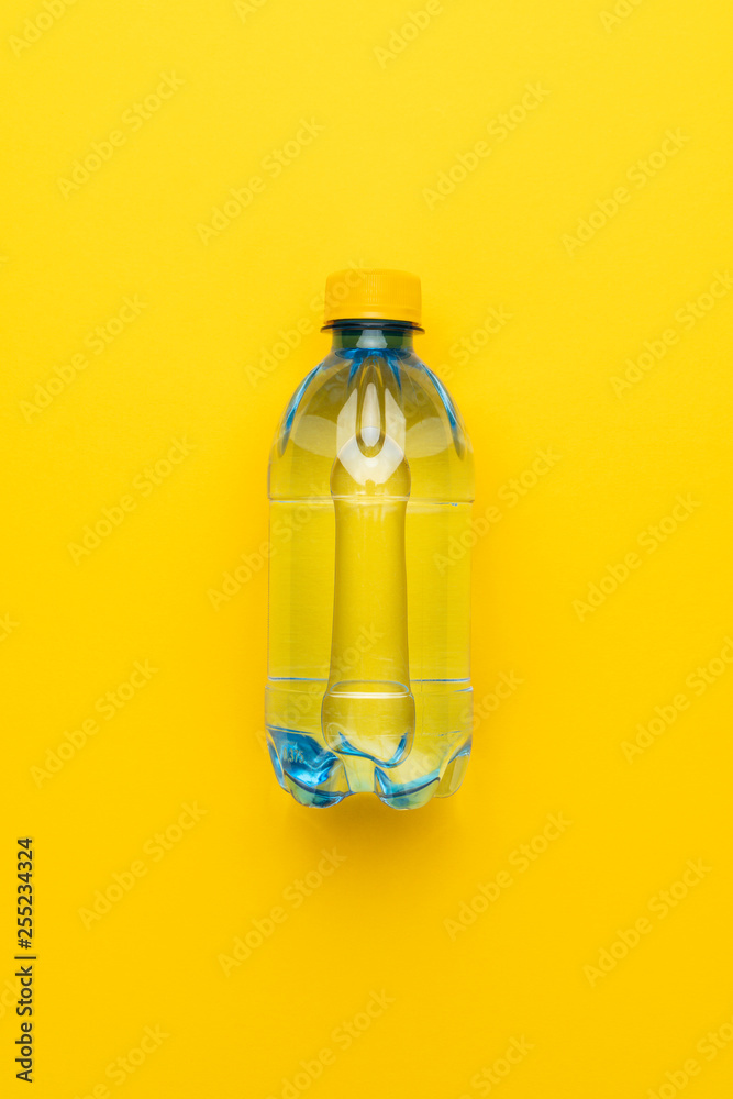 plastic water bottle with yellow cap on the yellow background plastic water bottle with yellow cap on the yellow background