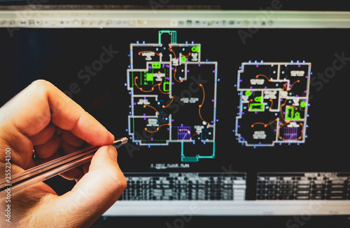 cad software drawing on the computer screen with hand holding pen photo