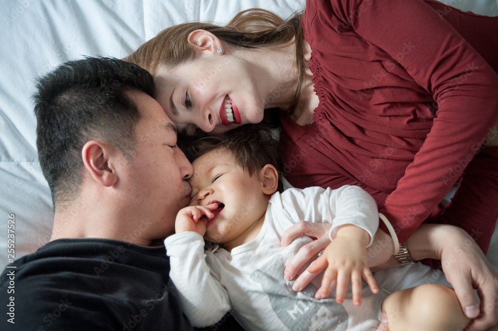 Family relaxing on bed at home Family relaxing on bed at home