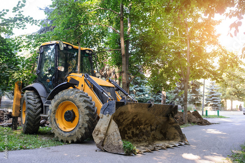 working excavator tractor digging a trench for pipenline