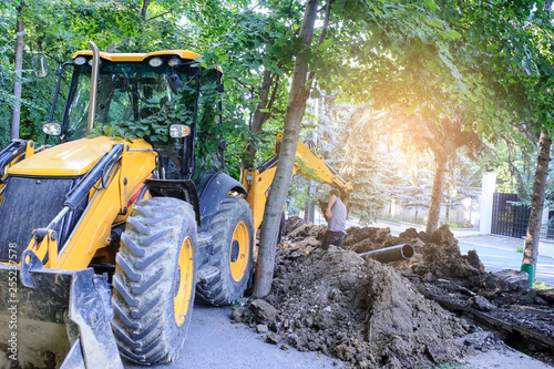 working excavator tractor digging a trench for pipenline
