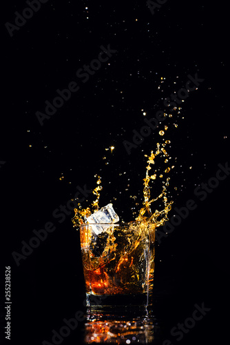 whiskey with splash on black background