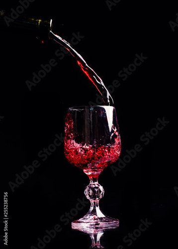Red wine pouring into wine glass