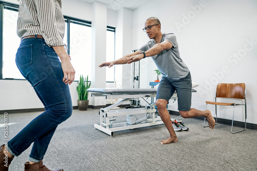 Physiotherapist examining a patient in clinic