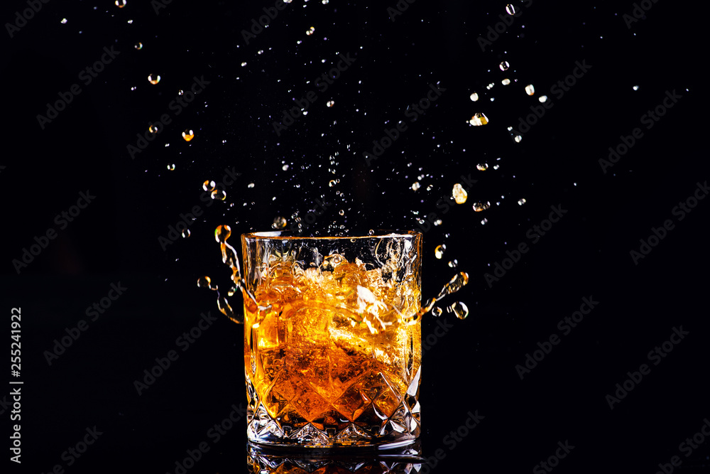 whiskey with splash on black background, brandy in a glass whiskey with splash on black background, brandy in a glass
