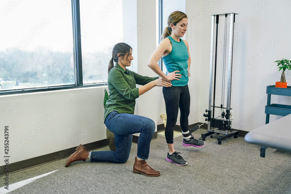 Physiotherapist helping her patient during exercise Physiotherapist helping her patient during exercise