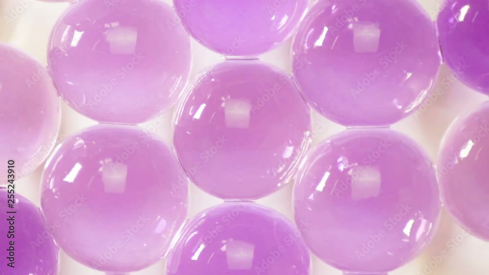 Purple hydrogel balls on a white background rotate Purple hydrogel balls on a white background rotate