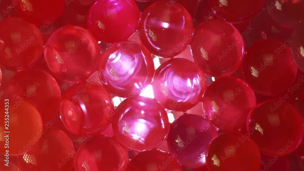 Light under the red hydrogel balls in the dark, rotation Light under the red hydrogel balls in the dark, rotation
