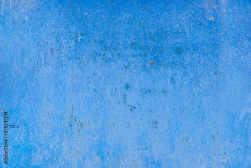 Texture of old battered concrete wall of blue color