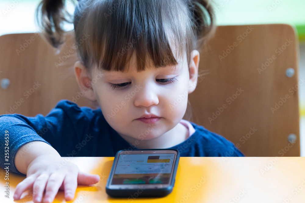 little child girl play on smartphone little child girl play on smartphone