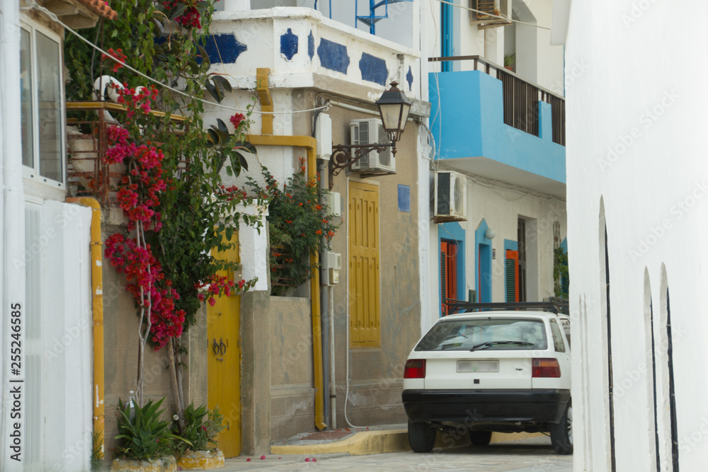 The landscape of the Greek city with a car