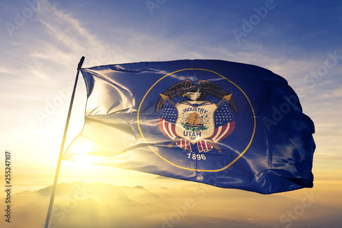 Utah state of United States flag waving on the top sunrise mist fog photo