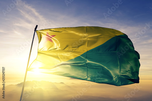 Acre state of Brazil flag waving on the top sunrise mist fog photo