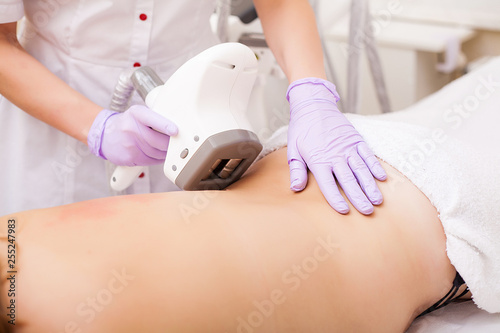 Body Care. Woman is in the process at the clinic lipomassage