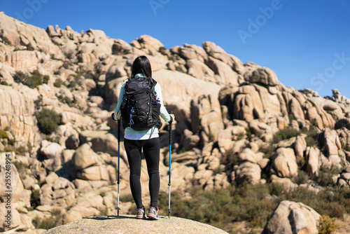 A young woman hiker in La Pedriza, National Park of mountain range of Guadarrama in Manzanares El Real, Madrid, Spain. photo