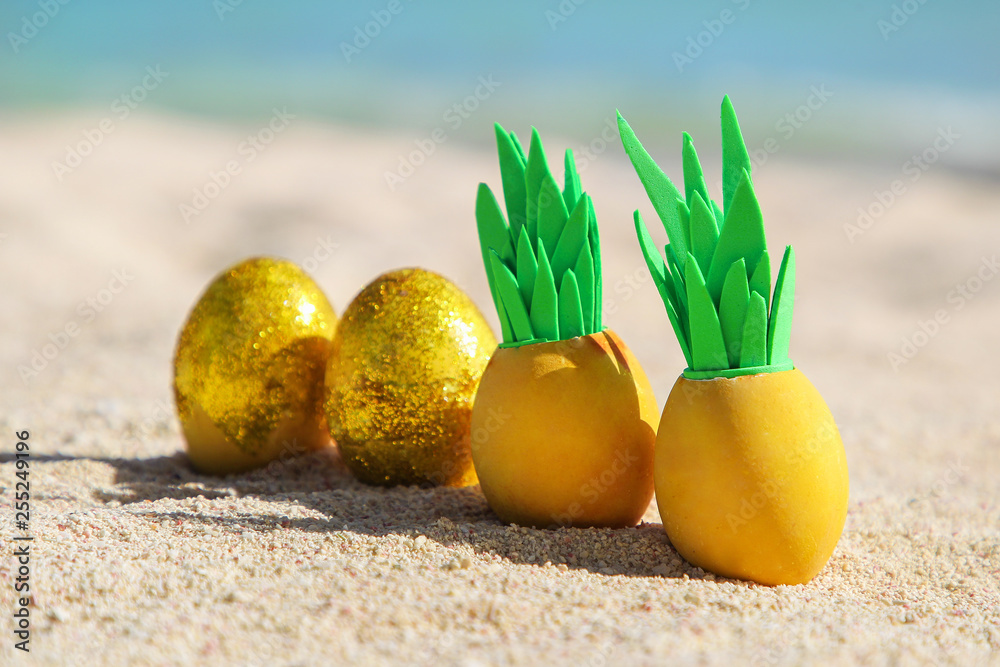 Easter eggs with pineapple leaves on the beach near the ocean Easter eggs with pineapple leaves on the beach near the ocean