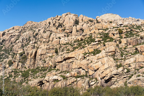 Panoramic view of granite rocks in La Pedriza, National Park of mountain range of Guadarrama in Manzanares El Real, Madrid, Spain.