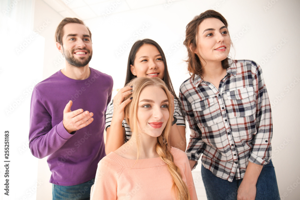 Professional hairdresser and trainees working with client in salon. Apprenticeship concept Professional hairdresser and trainees working with client in salon. Apprenticeship concept