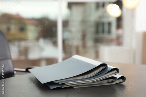 Stack of folders with documents on office table. Space for text photo