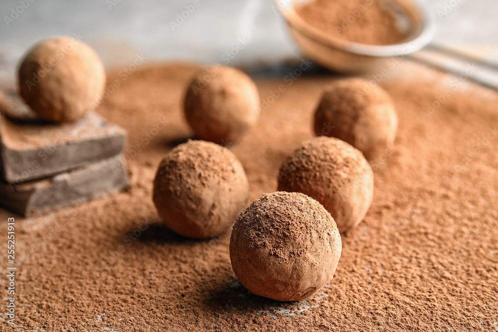 Sweet raw chocolate truffles powdered with cocoa on table Sweet raw chocolate truffles powdered with cocoa on table