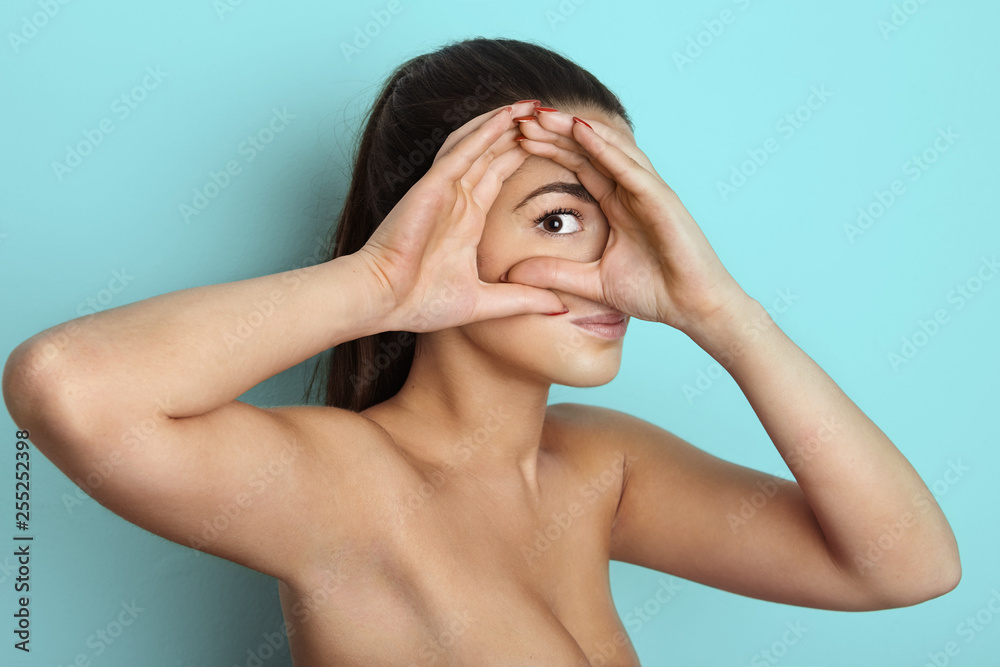 Portrait of beautiful young female woman with long curly hair, over light blue background.Vogue style portrait of beautiful delicate woman Portrait of beautiful young female woman with long curly hair, over light blue background.Vogue style portrait of beautiful delicate woman