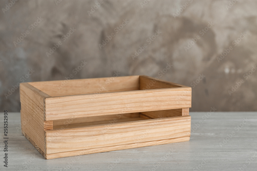 Wooden crate on table against color background. Space for text