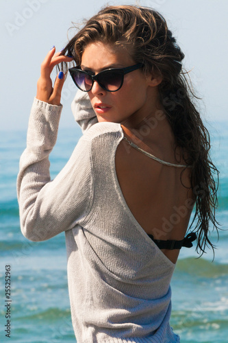 young beautiful woman portrait with sunglasses at sea beach summer