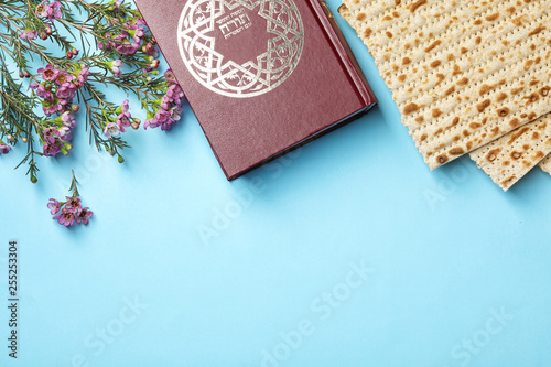 Flat lay composition with matzo and Torah on color background, space for text. Passover (Pesach) Seder