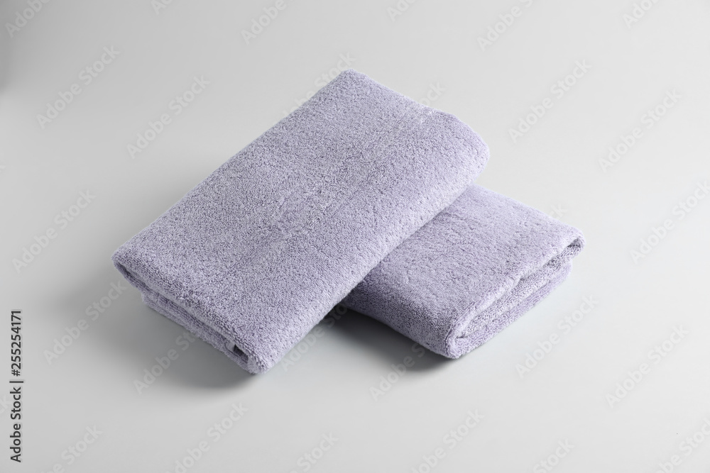 Fresh fluffy folded towels on grey background Fresh fluffy folded towels on grey background