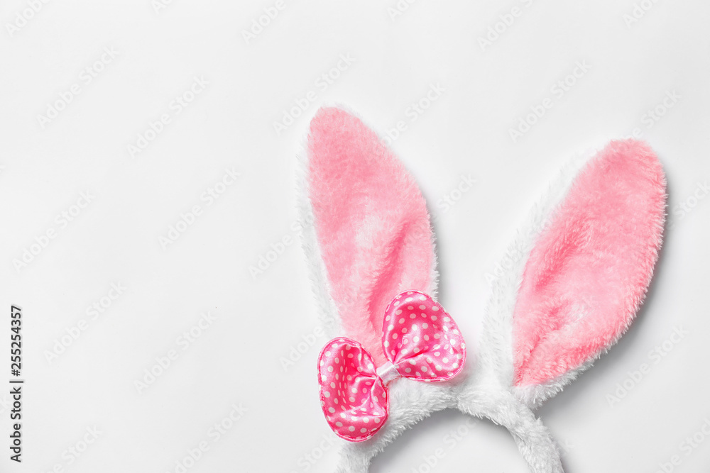 Funny headband with Easter bunny ears on white background, top view Funny headband with Easter bunny ears on white background, top view