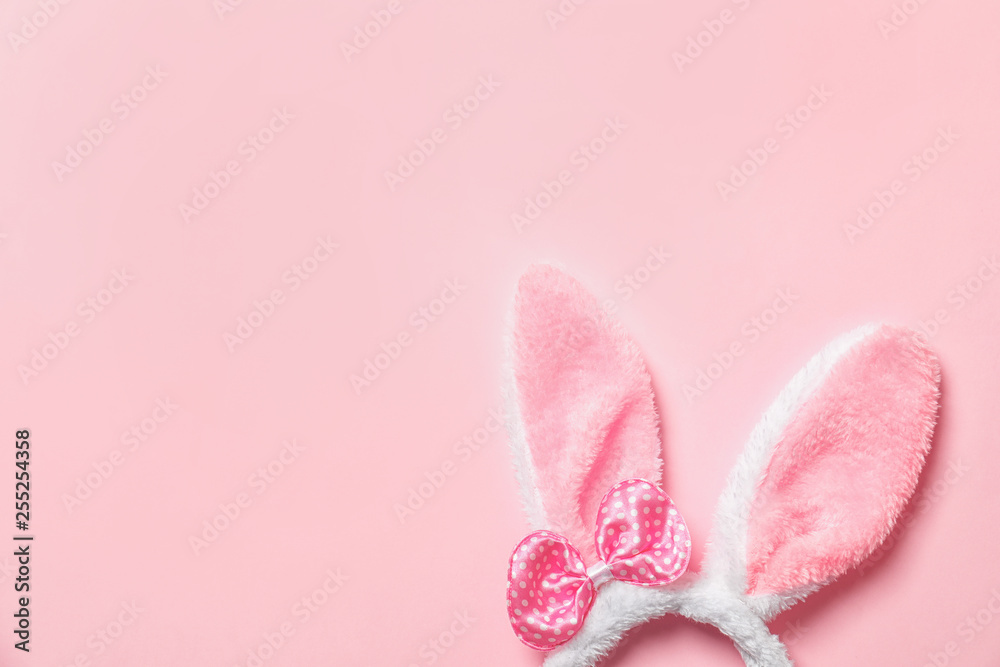 Funny headband with Easter bunny ears on color background, top view. Space for text Funny headband with Easter bunny ears on color background, top view. Space for text