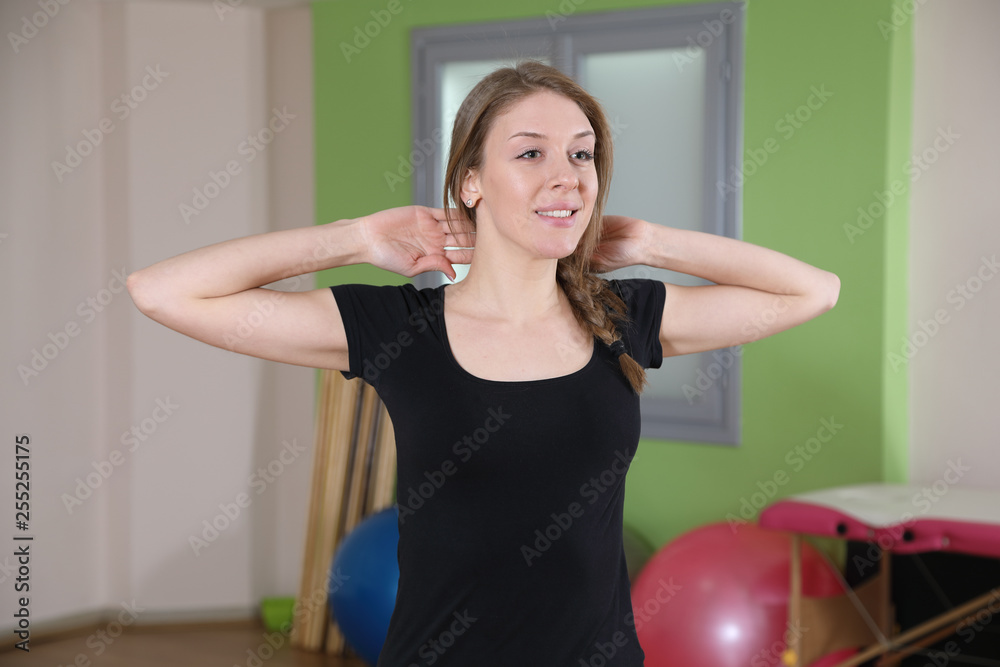 Young Smiling Woman Practicing Fitness, Doing Stretching Exercise In The Gym