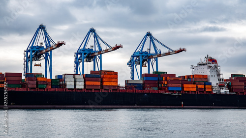 container ship being loaded at the Port of Genoa, Italy