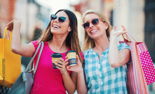 Shopping time. Young women shopping together. Consumerism, lifestyle concept