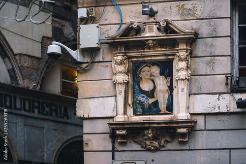 Madonna shrine on the facade of the old house in Genoa photo