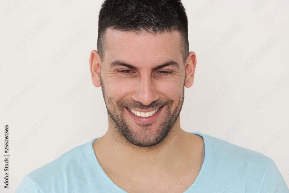 Close up portrait of cheerful satisfied attractive male smiling at the camera Close up portrait of cheerful satisfied attractive male smiling at the camera