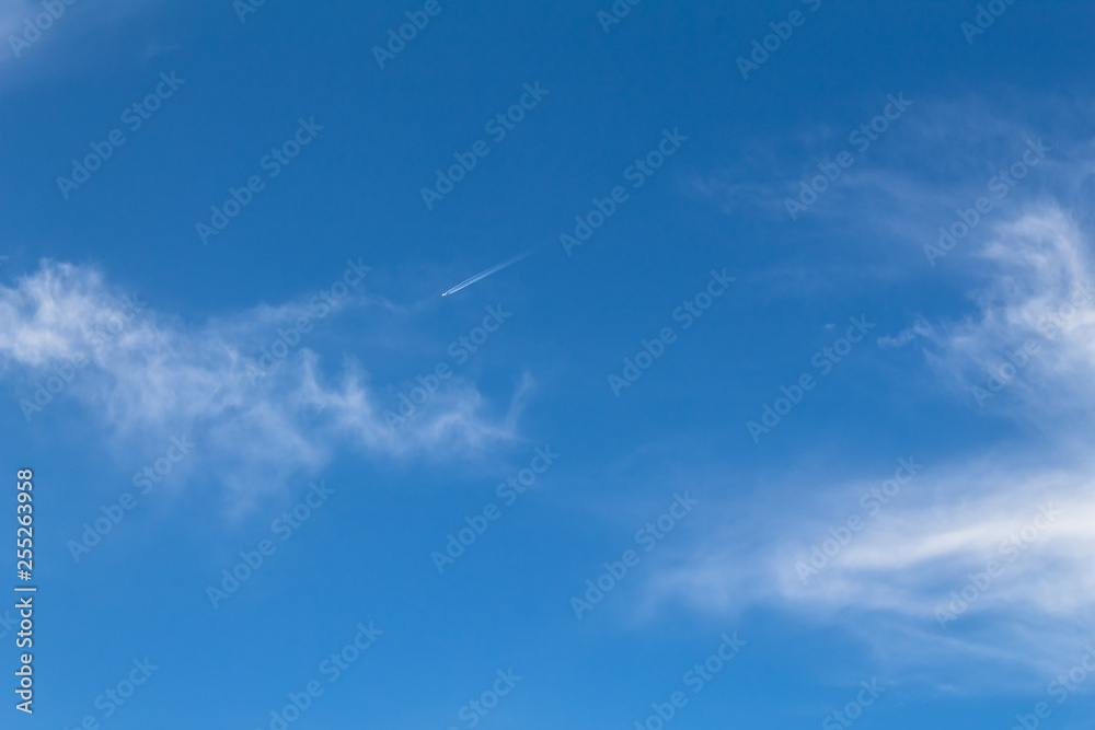 clear sky with small airplane in the distance
